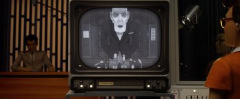 Movie still from “Isle of Dogs” (2018), directed by Wes Anderson – An old tv with a picture of a man on it; Medium shot, Low angle