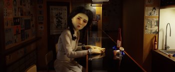 Movie still from “Isle of Dogs” (2018), directed by Wes Anderson – A woman sitting at a table in front of a bottle of wine; Close Up shot, Low angle