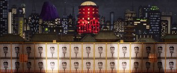 Movie still from “Isle of Dogs” (2018), directed by Wes Anderson – A bunch of posters that are in front of a building; Extreme Wide shot, Low angle