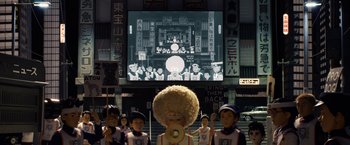 Movie still from “Isle of Dogs” (2018), directed by Wes Anderson – A group of people standing in front of a large screen; Extreme Wide shot, Low angle