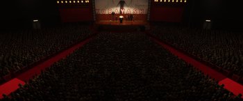 Movie still from “Isle of Dogs” (2018), directed by Wes Anderson – A large crowd of people in a large auditorium; Extreme Wide shot, High angle