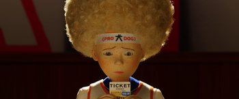 Movie still from “Isle of Dogs” (2018), directed by Wes Anderson – A person with a ticket on their head; Close Up shot, High angle