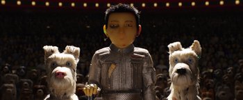 Movie still from “Isle of Dogs” (2018), directed by Wes Anderson – A man in a silver suit and some people in a crowd; Close Up shot, Low angle