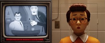 Movie still from “Isle of Dogs” (2018), directed by Wes Anderson – A person standing in front of a television; Close Up shot, Over the shoulder angle