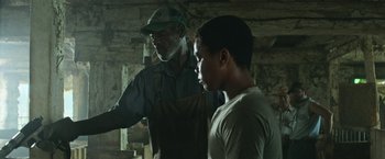 Movie still from “It” (2017), directed by Andy Muschietti – A man and a young boy in a room; Medium shot, Low angle