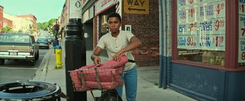 Movie still from “It” (2017), directed by Andy Muschietti – A boy is pushing a bicycle with a pink basket; Medium shot, Low angle