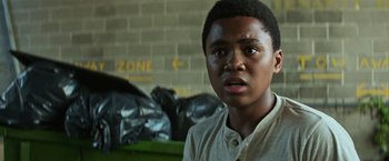 Movie still from “It” (2017), directed by Andy Muschietti – A young boy is looking at the camera; Close Up shot, Low angle