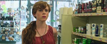 Movie still from “It” (2017), directed by Andy Muschietti – A woman standing in front of a mirror in a store; Close Up shot, Low angle