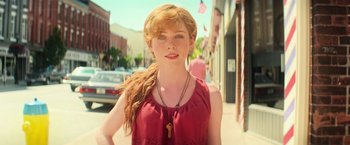 Movie still from “It” (2017), directed by Andy Muschietti – A beautiful young lady wearing a red dress; Close Up shot, Low angle