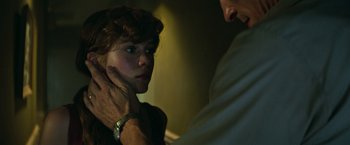 Movie still from “It” (2017), directed by Andy Muschietti – A young woman is being examined by an older man; Close Up shot, Over the shoulder angle