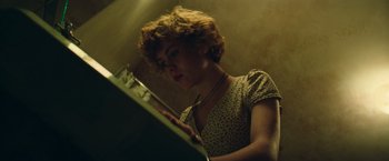 Movie still from “It” (2017), directed by Andy Muschietti – A woman is looking at her reflection in a mirror; Close Up shot, Low angle