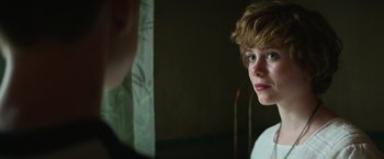 Movie still from “It” (2017), directed by Andy Muschietti – A young boy looking into a mirror in a dark room; Close Up shot, Over the shoulder angle