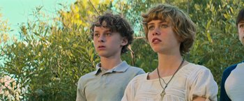 Movie still from “It” (2017), directed by Andy Muschietti – Two young men standing next to each other in front of trees; Close Up shot, Low angle