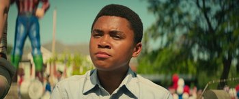 Movie still from “It” (2017), directed by Andy Muschietti – A young black man with his head tilted to the side; Close Up shot, Low angle