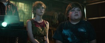 Movie still from “It” (2017), directed by Andy Muschietti – A boy and a girl standing next to each other; Medium shot, Low angle