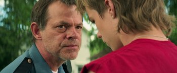 Movie still from “It” (2017), directed by Andy Muschietti – An older man and a younger man face to face; Close Up shot, Over the shoulder angle