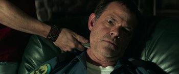 Movie still from “It” (2017), directed by Andy Muschietti – A man is getting his hair cut by another man; Close Up shot, Over the shoulder angle