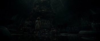 Movie still from “It” (2017), directed by Andy Muschietti – A woman standing in the dark in front of an abandoned building; Extreme Wide shot, Low angle