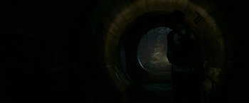 Movie still from “It” (2017), directed by Andy Muschietti – A tunnel with a person standing in it; Wide shot, High angle