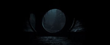 Movie still from “It” (2017), directed by Andy Muschietti – A dark tunnel with a person standing in it; Extreme Wide shot, Low angle