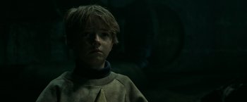 Movie still from “It” (2017), directed by Andy Muschietti – A young boy is looking into the camera; Close Up shot, Over the shoulder angle