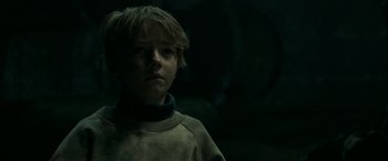 Movie still from “It” (2017), directed by Andy Muschietti – A young boy is looking at the camera; Close Up shot, Low angle