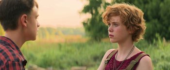 Movie still from “It” (2017), directed by Andy Muschietti – A woman with red hair and a red dress; Close Up shot, Over the shoulder angle
