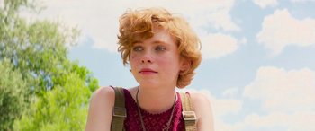 Movie still from “It Chapter Two” (2019), directed by Andy Muschietti – A young woman with red curly hair wearing a red top; Close Up shot, Over the shoulder angle