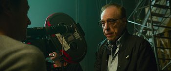 Movie still from “It Chapter Two” (2019), directed by Andy Muschietti – An older man with glasses is holding a camera; Close Up shot, Low angle