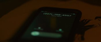 Movie still from “It Chapter Two” (2019), directed by Andy Muschietti – A phone number is displayed on the screen of a cell phone; Extreme Close Up shot, High angle