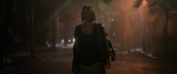 Movie still from “It Chapter Two” (2019), directed by Andy Muschietti – A woman is walking in the rain at night; Wide shot, Low angle