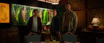 Movie still from “It Chapter Two” (2019), directed by Andy Muschietti – A group of men standing next to each other in front of a fish tank; Wide shot, Low angle
