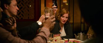 Movie still from “It Chapter Two” (2019), directed by Andy Muschietti – A woman sitting at a table with a glass of water; Medium shot, Over the shoulder angle