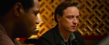 Movie still from “It Chapter Two” (2019), directed by Andy Muschietti – A man sitting in front of another man in front of a wooden wall; Close Up shot, Over the shoulder angle