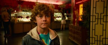 Movie still from “It Chapter Two” (2019), directed by Andy Muschietti – A young boy is standing in a room; Close Up shot, Over the shoulder angle