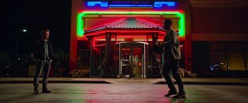 Movie still from “It Chapter Two” (2019), directed by Andy Muschietti – A man walking down the sidewalk in front of a restaurant; Wide shot, Low angle