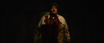 Movie still from “It Chapter Two” (2019), directed by Andy Muschietti – A man with blood all over his face and chest; Medium shot, Low angle