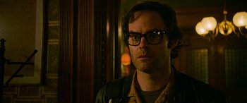 Movie still from “It Chapter Two” (2019), directed by Andy Muschietti – A person wearing glasses and a leather jacket; Close Up shot, Over the shoulder angle