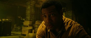 Movie still from “It Chapter Two” (2019), directed by Andy Muschietti – A person in a room with books; Close Up shot, High angle