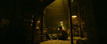 Movie still from “It Chapter Two” (2019), directed by Andy Muschietti – Two people sitting on the ground in a warehouse; Wide shot, High angle