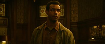 Movie still from “It Chapter Two” (2019), directed by Andy Muschietti – A man standing in front of stained glass window; Close Up shot, Low angle