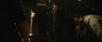 Movie still from “It Chapter Two” (2019), directed by Andy Muschietti – A man standing in a dark room with his hands in his pockets; Medium shot, Low angle