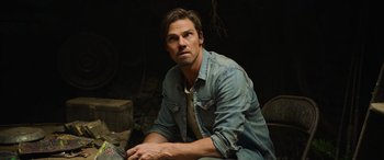 Movie still from “It Chapter Two” (2019), directed by Andy Muschietti – A man sitting on the ground wearing a jean jacket; Close Up shot, Low angle