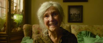 Movie still from “It Chapter Two” (2019), directed by Andy Muschietti – An older woman with white hair smiling for the camera; Close Up shot, High angle