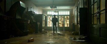 Movie still from “It Chapter Two” (2019), directed by Andy Muschietti – A man standing in a room with a lot of debris; Wide shot, Low angle