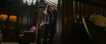 Movie still from “It Chapter Two” (2019), directed by Andy Muschietti – A woman sitting on the steps of a staircase; Medium shot, Low angle