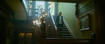 Movie still from “It Chapter Two” (2019), directed by Andy Muschietti – A woman walking up the stairs of a house; Wide shot, Low angle