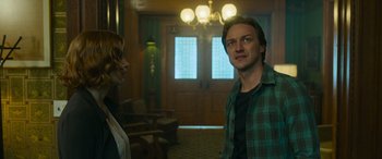 Movie still from “It Chapter Two” (2019), directed by Andy Muschietti – A man and a woman standing in front of a door; Medium shot, Low angle