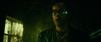 Movie still from “It Chapter Two” (2019), directed by Andy Muschietti – A man wearing glasses and a green jacket; Close Up shot, Low angle