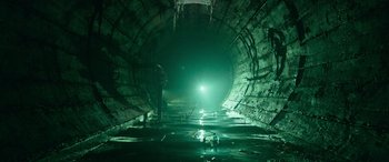Movie still from “It Chapter Two” (2019), directed by Andy Muschietti – A man standing in the middle of an underground tunnel; Extreme Wide shot, High angle